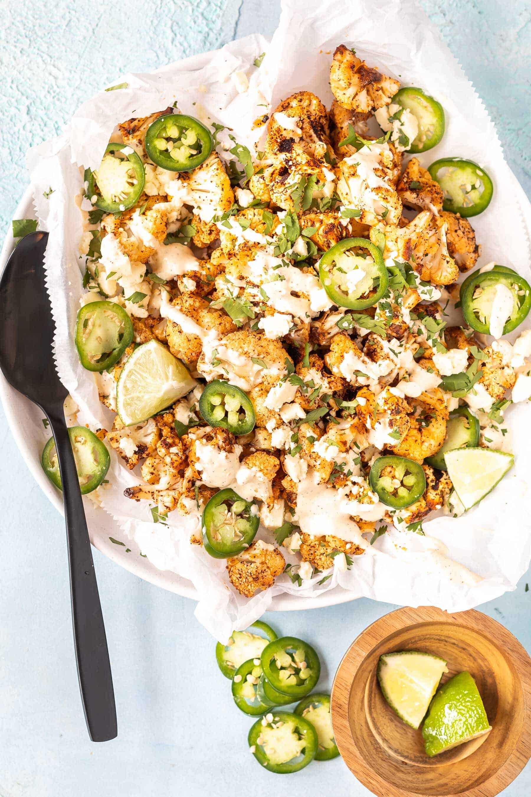 roasted cauliflower on plate with toppings