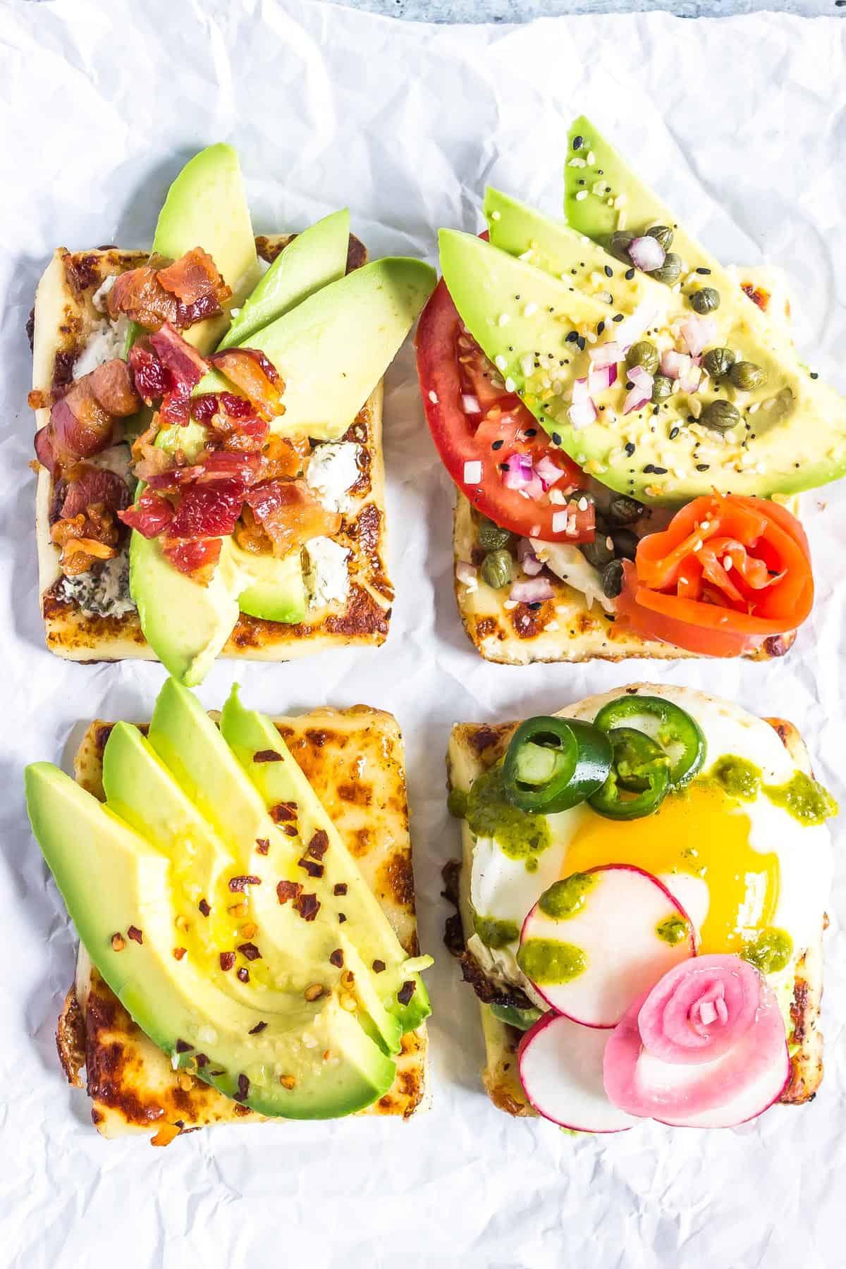 keto avocado toasts presented 4 ways: with avocado goat cheese bacon, lox, simple, and fried egg style.