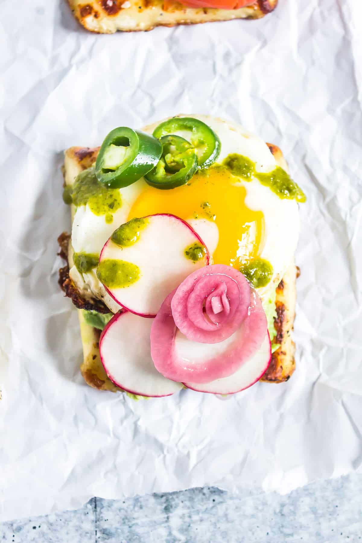 fried egg, pickled onion, jalapenos, and radish on toasted bread cheese