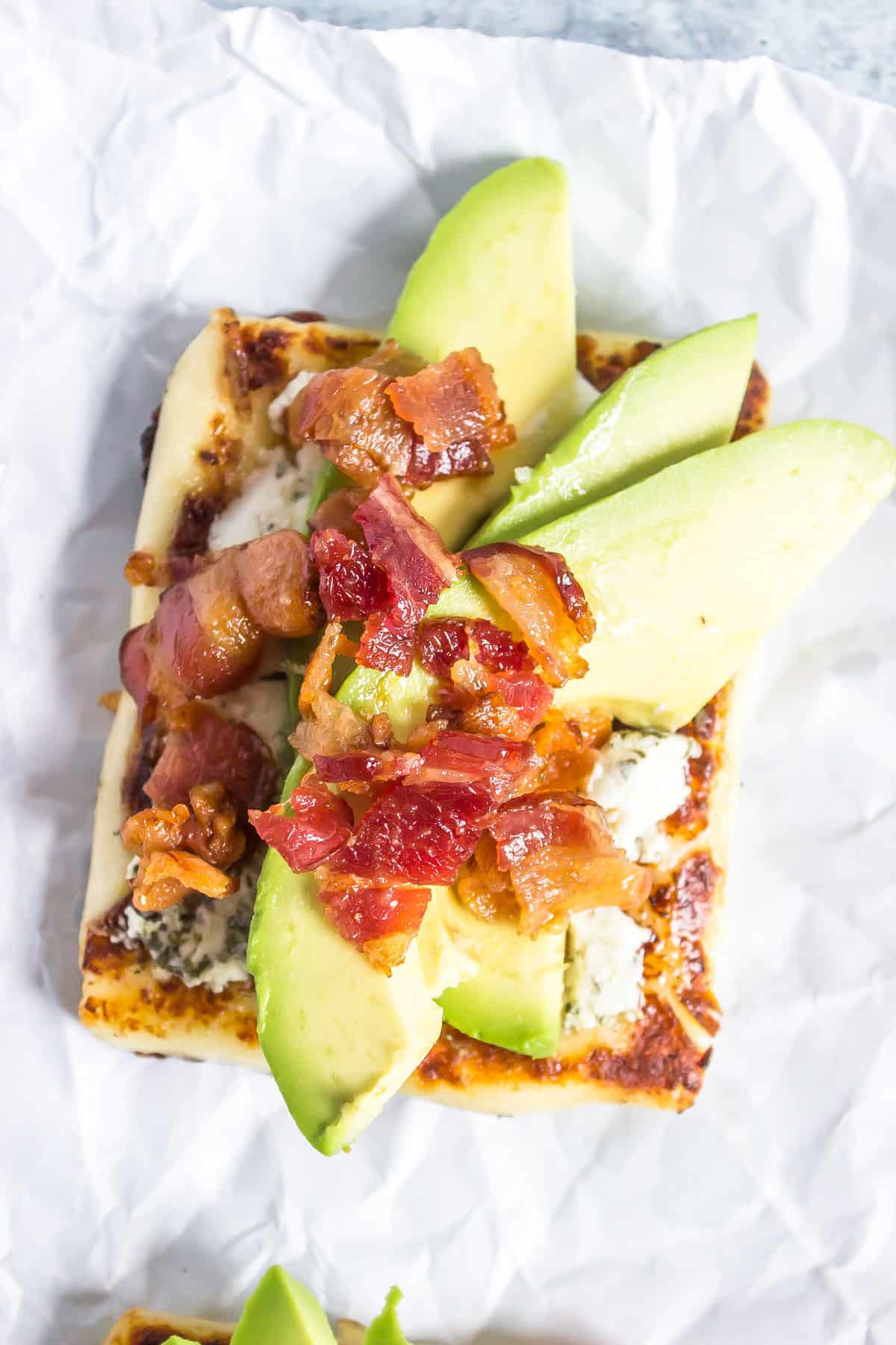 goat cheese, bacon, and avocado on bread cheese